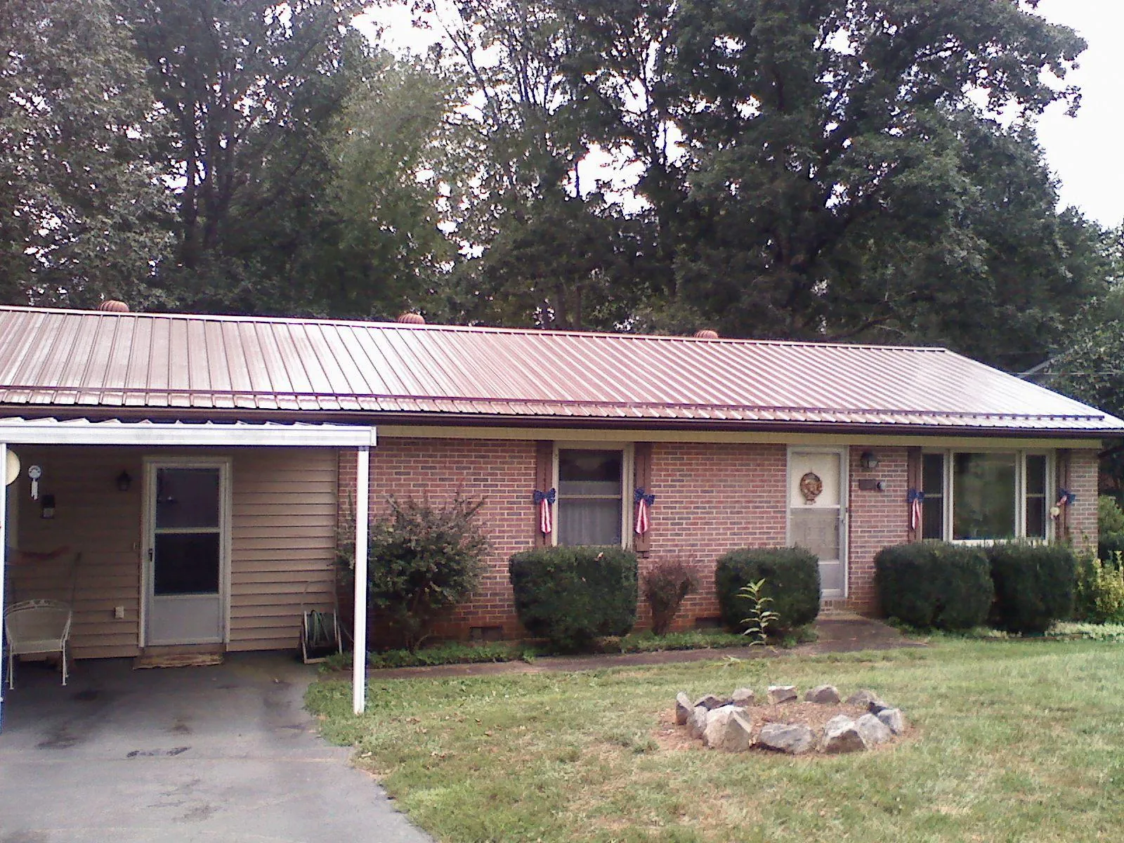Bronze metal roof and carport on a brick ranch home in Dallas